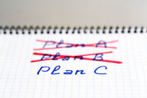 Plans A and B failed we need plan C Handwritten phrases PLAN A and B crossed out with red pencil PLAN C phrase written below